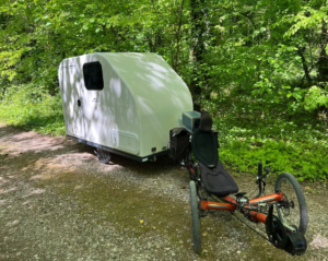 Tiny bike camper expands via slide-out to sleep 2 people + toilet
