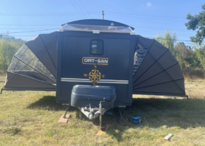 Expandable camper nearly triples living space with huge folding wings